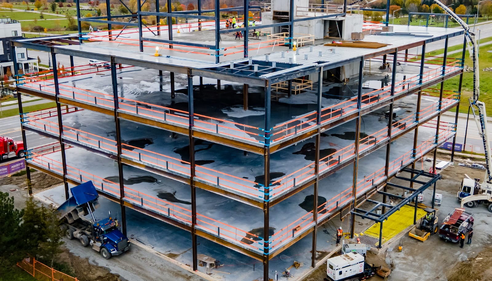 StrapRail providing fall protection for workers on all levels of a large steel building.