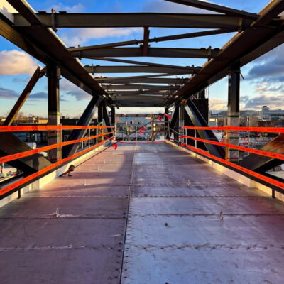 StrapRail easily provides fall protection during construction of an overhead walkway.